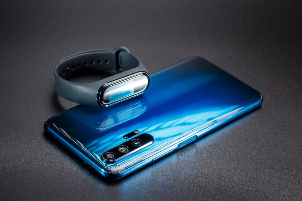 Huawei smartphone and fitness band on a dark surface